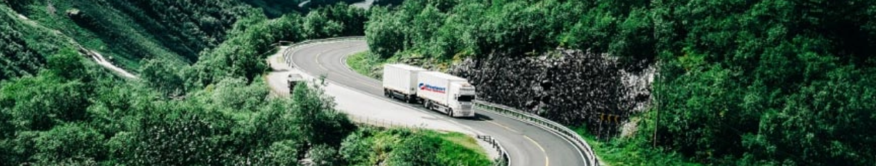 Wesport branded truck driving along a hillside road