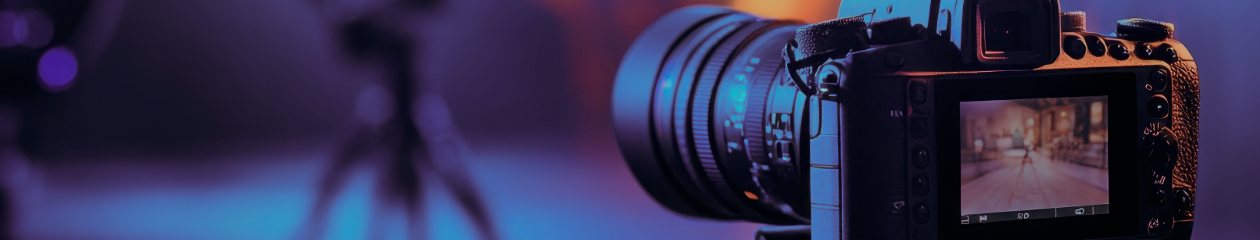 A camera is seen in the foreground as it captures an event or scene off-screen