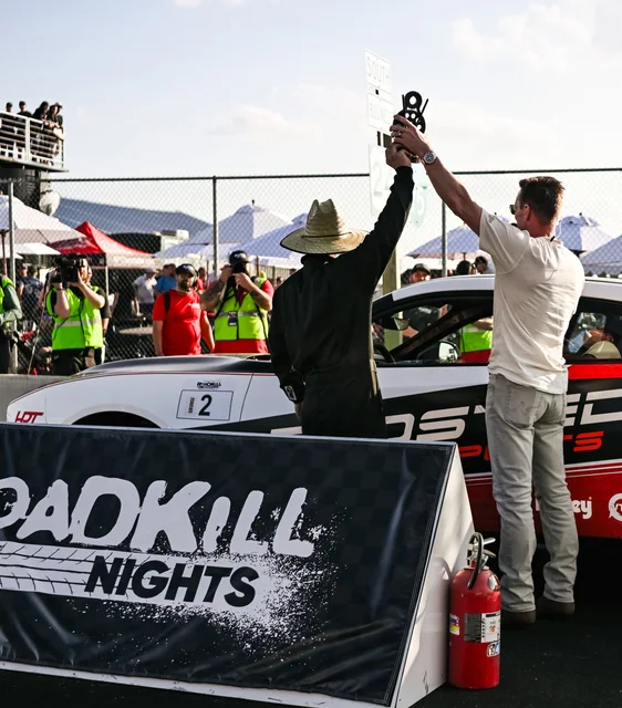 Roadkill Nights winner celebrating beside a Dodge car